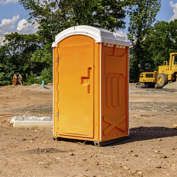 what is the cost difference between standard and deluxe portable restroom rentals in Raymond